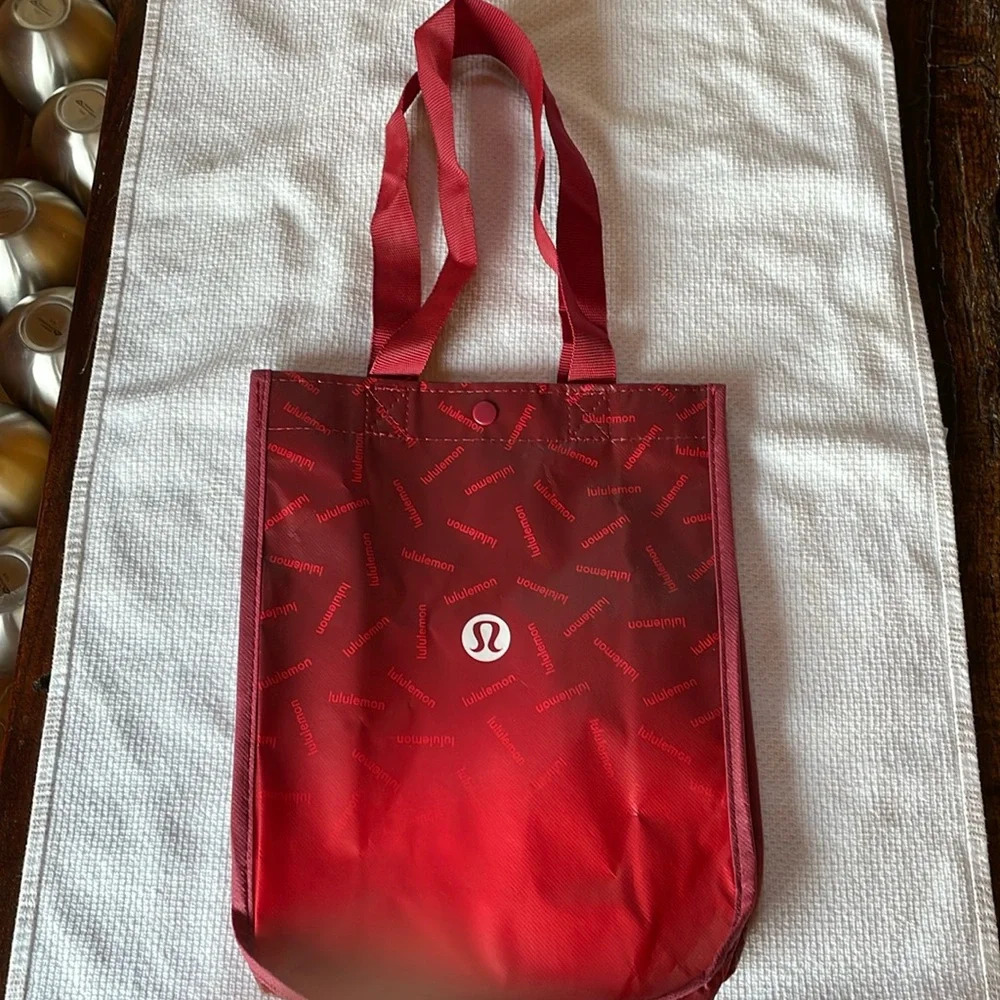 LULULEMON RED REUSABLE SMALL TOTE. Ombré w/ lululemon hits scattered all over